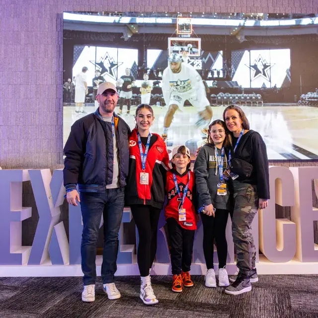 A family of basketball fans attends the NBA All-Star Game festivities.