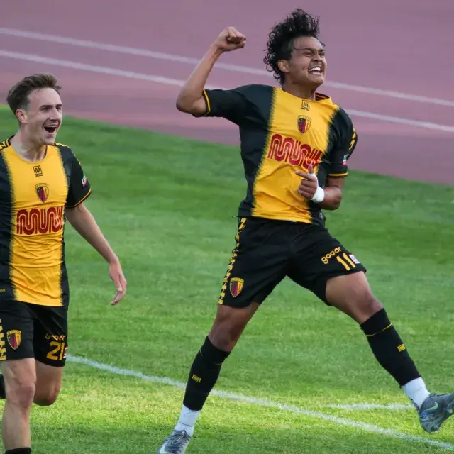 SF City FC players jumping for joy on Kezar Stadium field