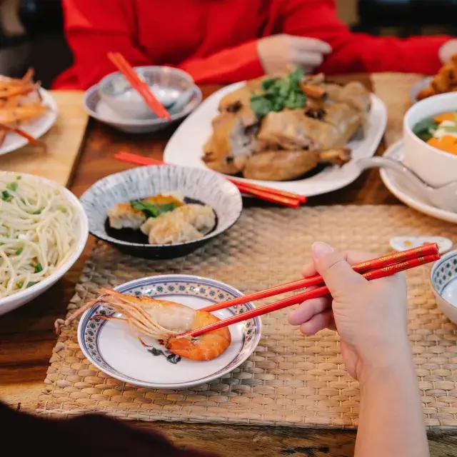 Spread of Chinese food in front of diners at a restaurant