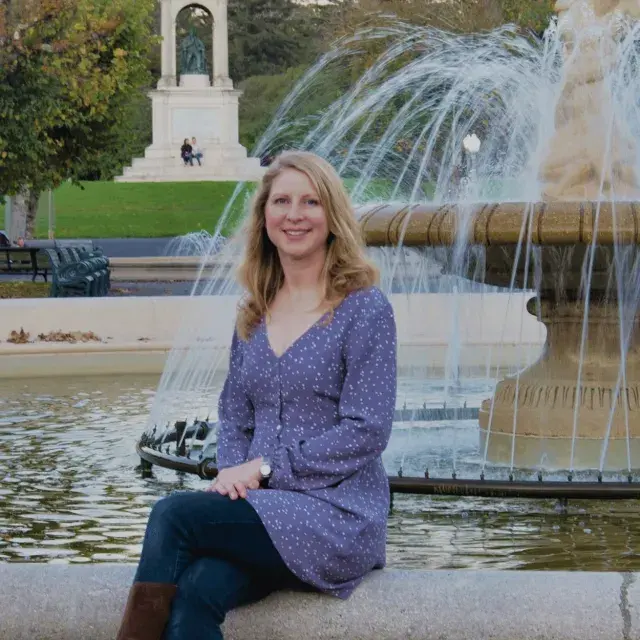 Author Marta Lindsey sits at a fountain in Golden Gate Park's Music Concourse.
