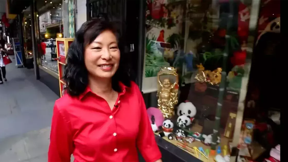 Linda Lee walks through the streets of Chinatown wearing a red shirt. San Francisco, CA.